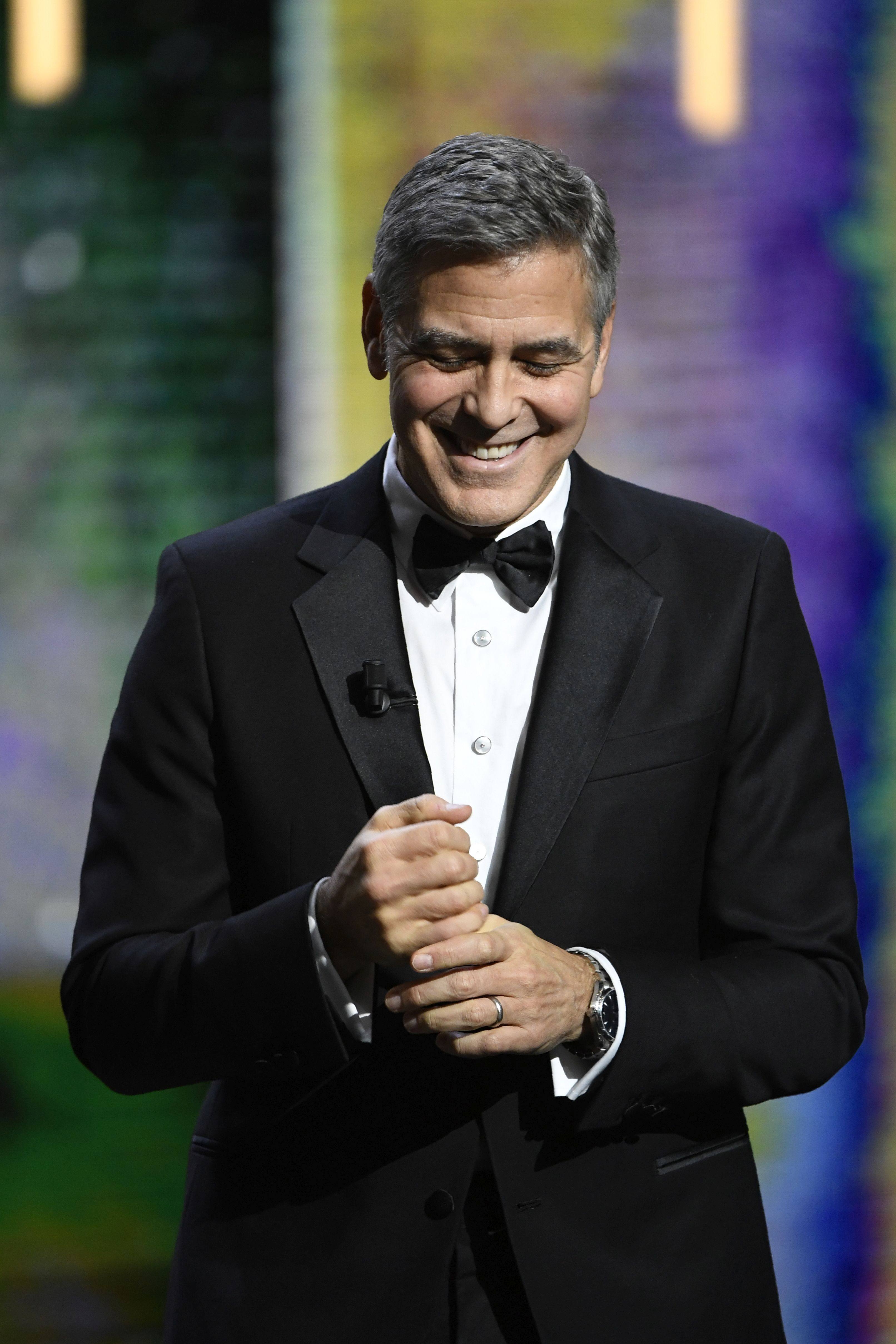 US actor George Clooney arrives on stage to receive an honorary award during the 42nd edition of the Cesar Ceremony at the Salle Pleyel in Paris on February 24, 2017. / AFP / bertrand GUAY (Photo credit should read BERTRAND GUAY/AFP/Getty Images)
